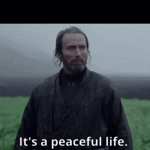 a man standing in a field with the words it 's a peaceful life