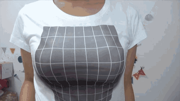 a woman is wearing a white t-shirt with a grid pattern