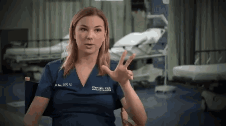 a woman wearing a scrub top that says crawford hospital