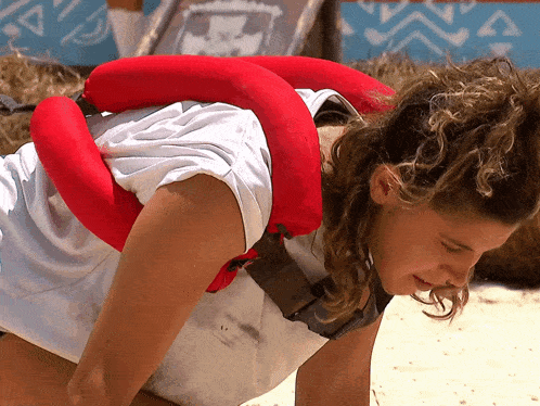 a woman is wearing a red life preserver around her neck