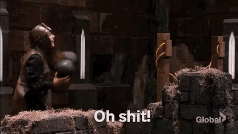 a man in a helmet is standing in front of a wooden torture device and saying `` oh shit ! ''