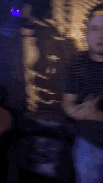 a blurry picture of a man wearing a striped shirt and a hat