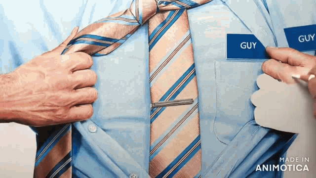 a man in a tie has a name tag that says guy on it