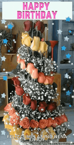 a christmas tree made of roses and baby 's breath says happy birthday