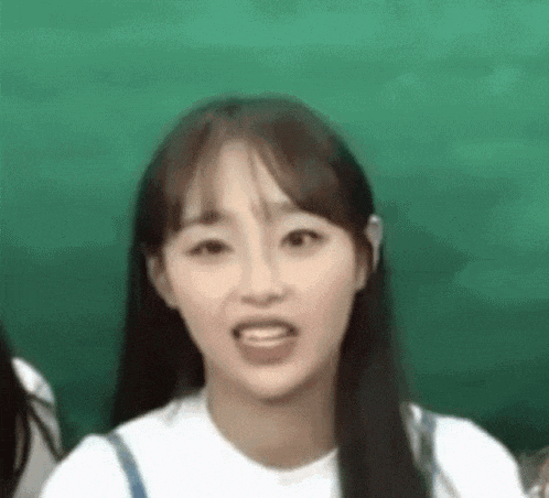 a close up of a girl making a funny face .