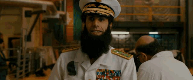 a man with a beard is wearing a military uniform with a badge that says ' us navy ' on it