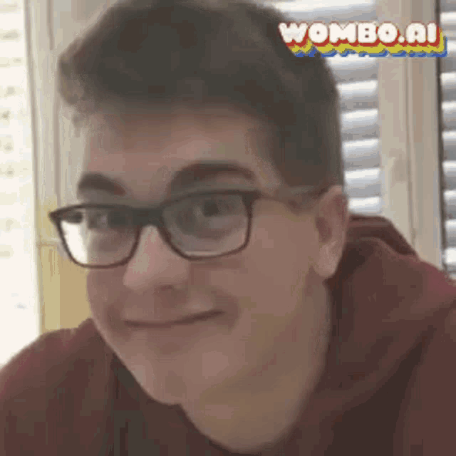a young man wearing glasses and a red hoodie is smiling and looking at the camera .