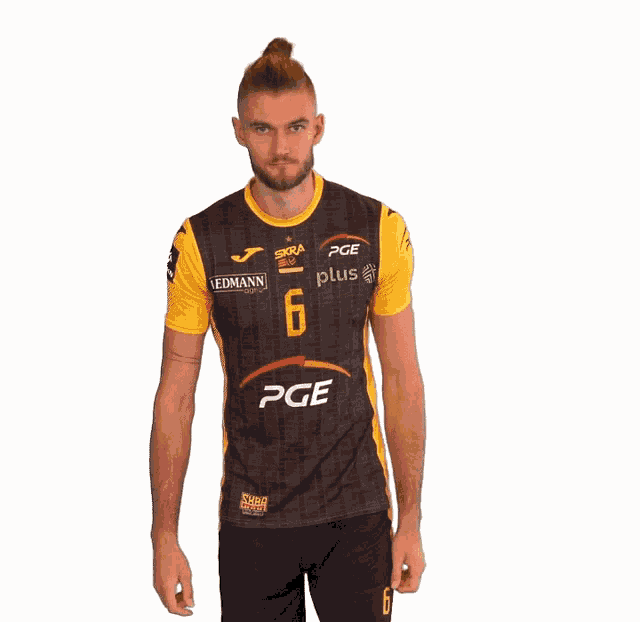 a man is wearing a black and yellow jersey with the number 6 on it