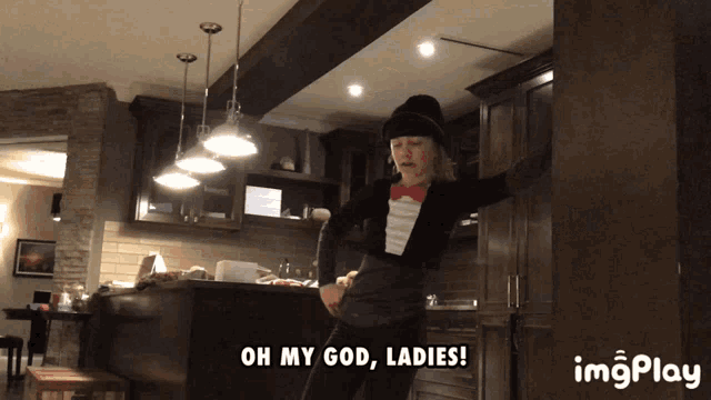 a woman in a tuxedo says " oh my god ladies " in a kitchen
