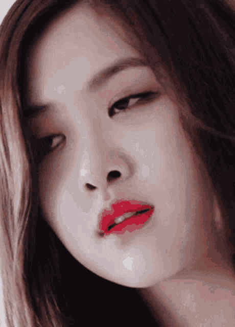 a close up of a woman with red lipstick on her lips .