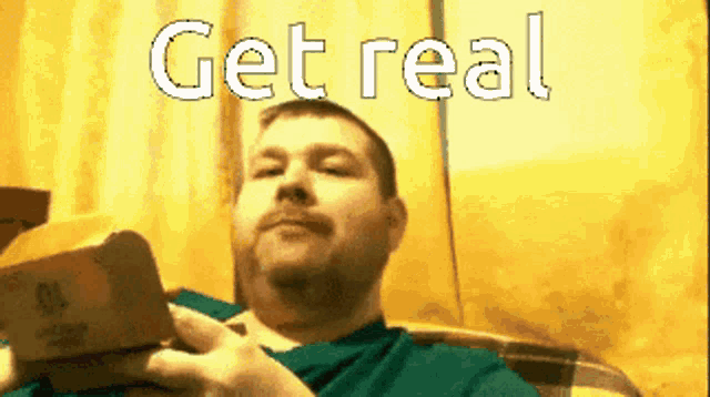 a man sitting on a couch with the words get real on the screen