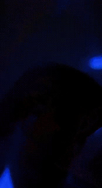 a blurred image of a person 's face with red and green lights behind them
