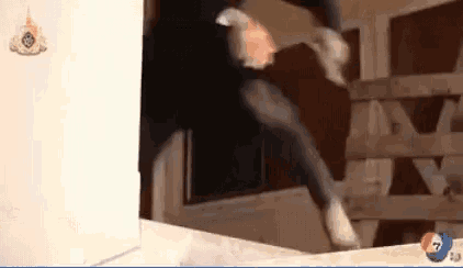 a man is jumping over a wooden fence in a video