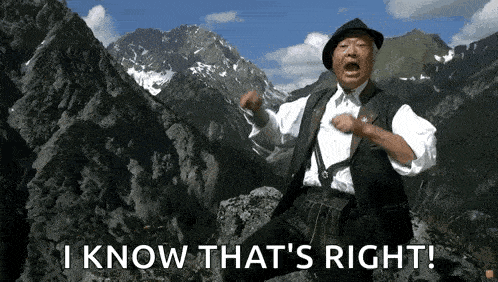 a man is standing on top of a mountain and says i know that 's right