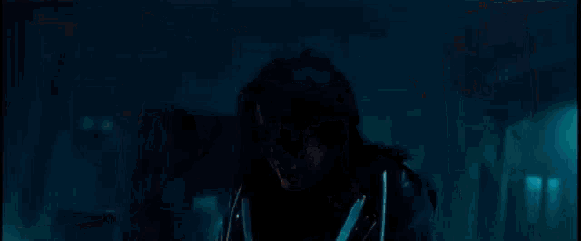a group of soldiers are standing in a dark room holding guns and shooting .