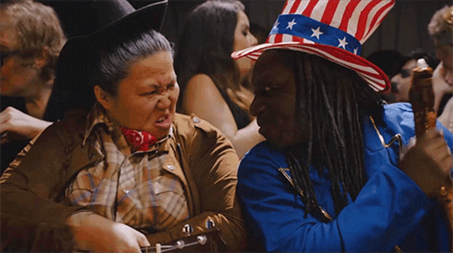 a man in an uncle sam costume talks to a woman in a cowboy outfit