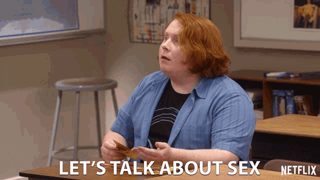 a woman sits at a desk with the words let 's talk about sex written below her