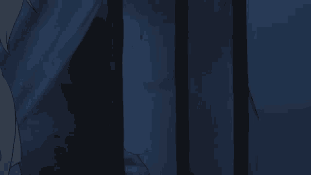 a dark room with a blue curtain hanging on a wall