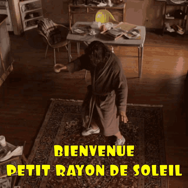 a man in a robe is dancing in a room with the words bienvenue petit rayon de soleil on the bottom