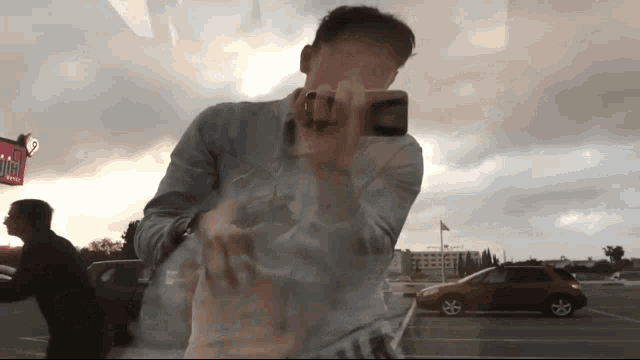 a man taking a selfie in front of a wendy 's restaurant
