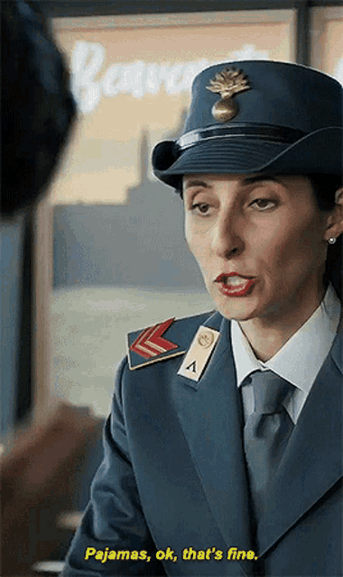 a woman in a military uniform is talking to a man and saying pajamas ok that 's fine