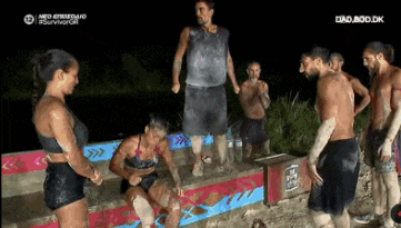a group of people are standing on a wall with the word survivor on the bottom
