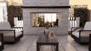 a living room with a fireplace and a table with a vase of flowers on it