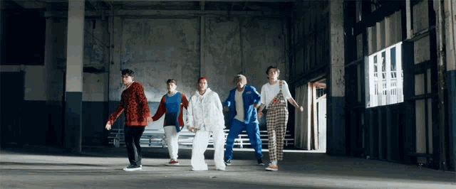 a group of people are dancing in a room with a sign that says ' ii ' on it