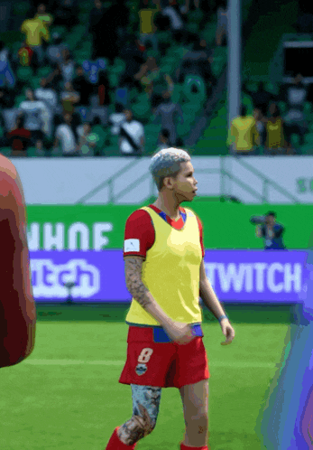 a soccer player wearing a yellow vest with the number 8 on it