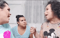 a group of women are standing next to each other in a room .