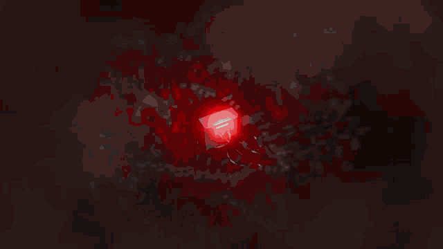 a group of cheerleaders are dancing in a dark room with red lights behind them