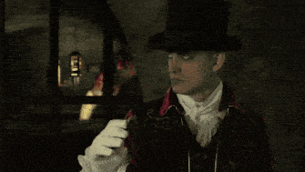 a man in a top hat holds a sword in his right hand