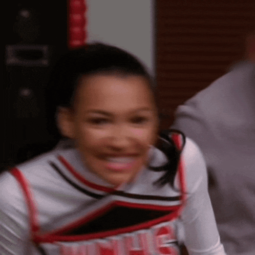 a cheerleader wearing a uniform that says ' nc ' on it is smiling