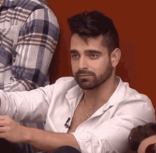 a man with a beard wearing a white shirt