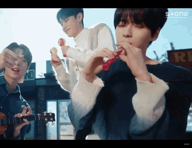 a group of young men playing instruments in front of a sign that says ' s + one ' on it
