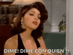 a woman in a black dress is sitting in a chair and saying dime dime con quien .