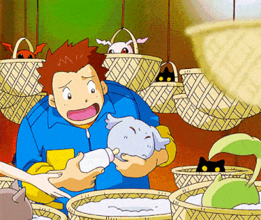 a man in a blue jacket is holding a baby bottle