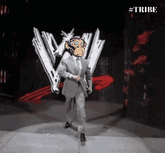 a man in a suit and tie is walking on a stage in front of a wwe logo