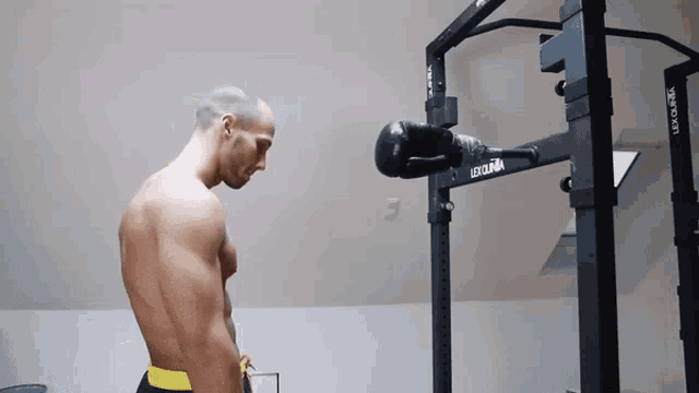a shirtless man is standing in front of a machine that says lee on it