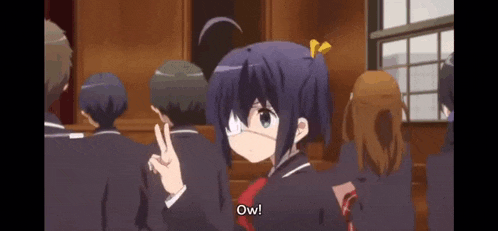a girl with a bandage on her eye is giving a peace sign in front of a group of people .