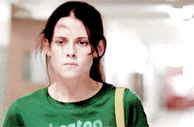 a woman wearing a green t-shirt with the word boston on it