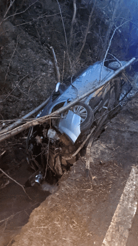 a car that has fallen on its side on the road