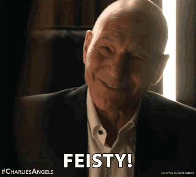 an older man in a suit and white shirt is smiling and says feisty