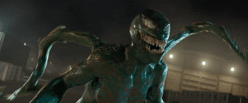 a statue of a monster with its mouth open is standing in the dark