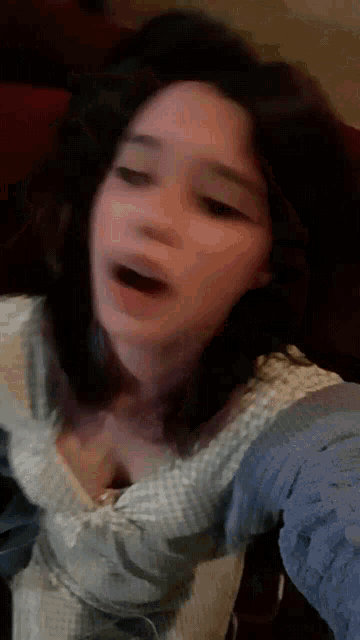 a blurry picture of a woman making a funny face