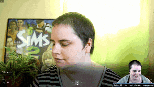 a woman in front of a sign that says sims 2