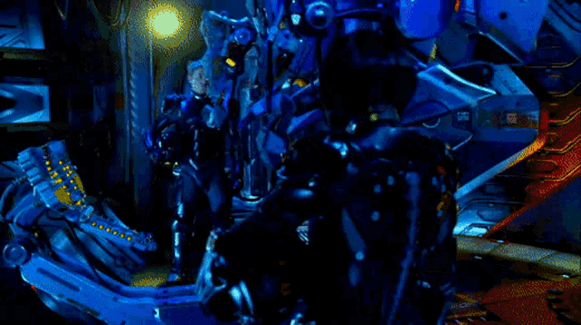 a man in a blue suit stands next to a robot in a dark room