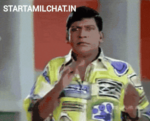 a man in a colorful shirt is standing in front of a sign that says startamilchat.in