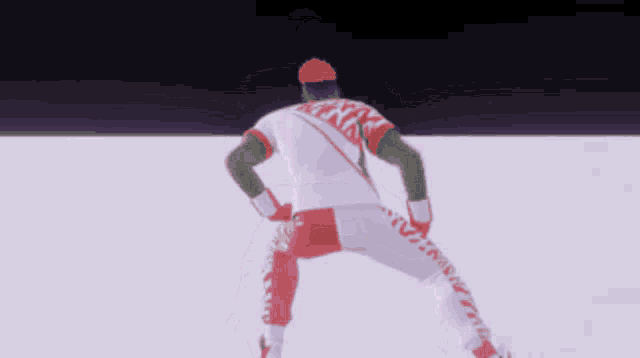 a man wearing a red and white outfit with the word nike on the back of his shirt