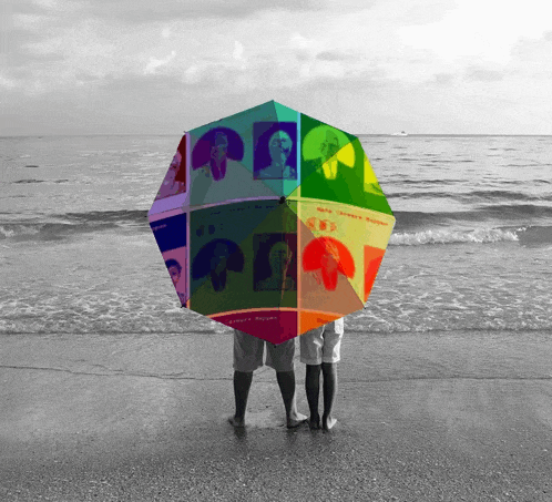 a couple standing under a colorful umbrella that says ' sakura ' on the bottom